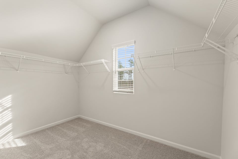 A room with a window and a carpet.