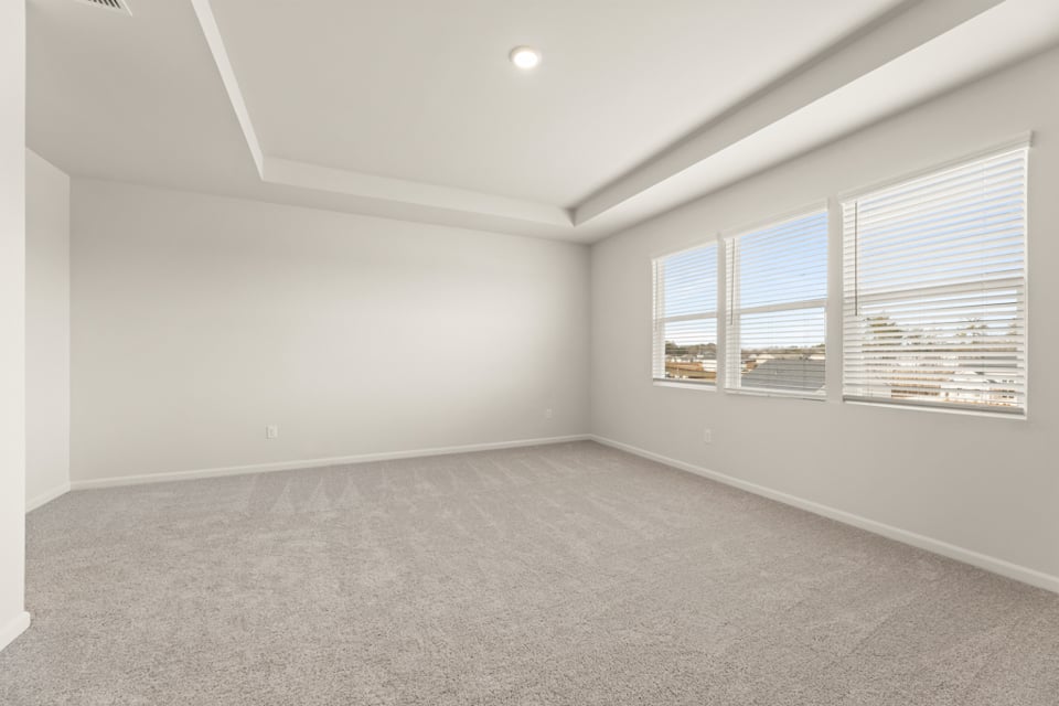 A room with a window and a carpet.