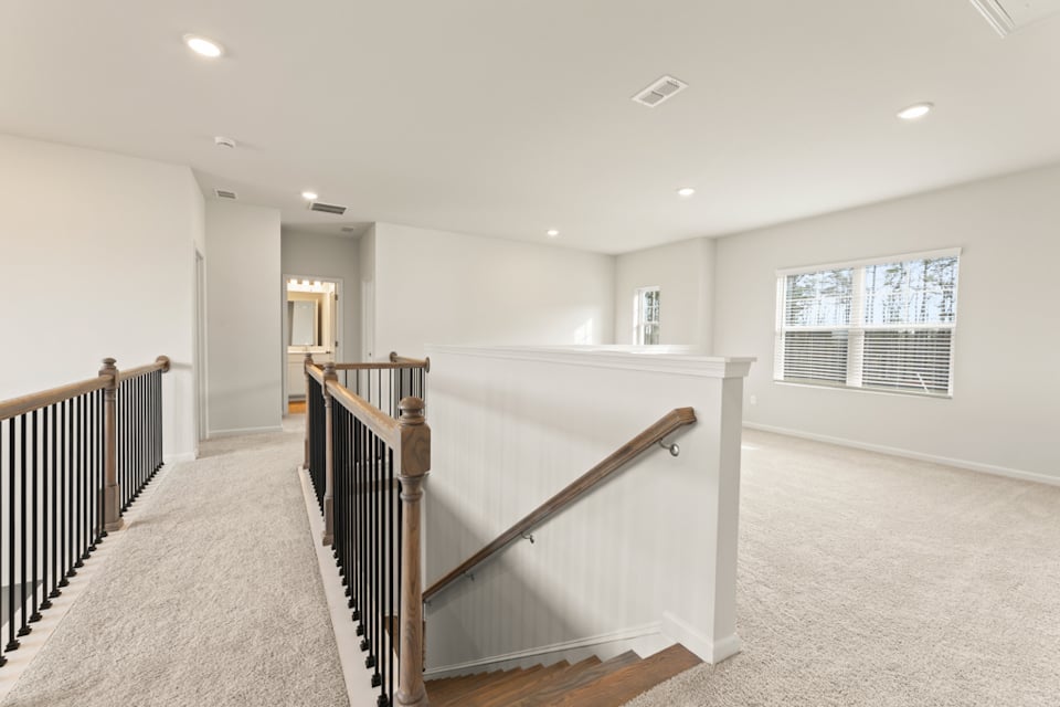 A large white room with a staircase.