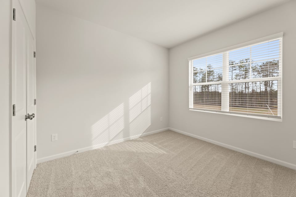 A room with a window and a door.