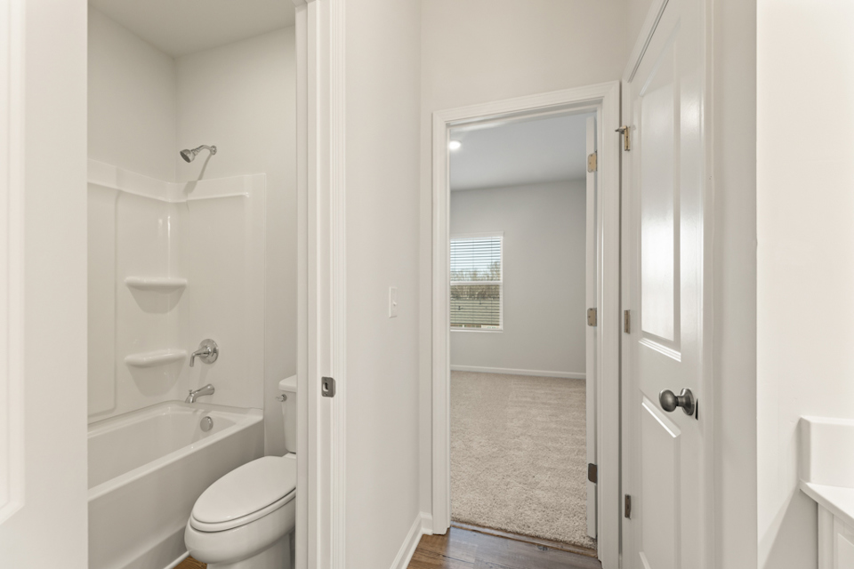 A bathroom with a shower and toilet.