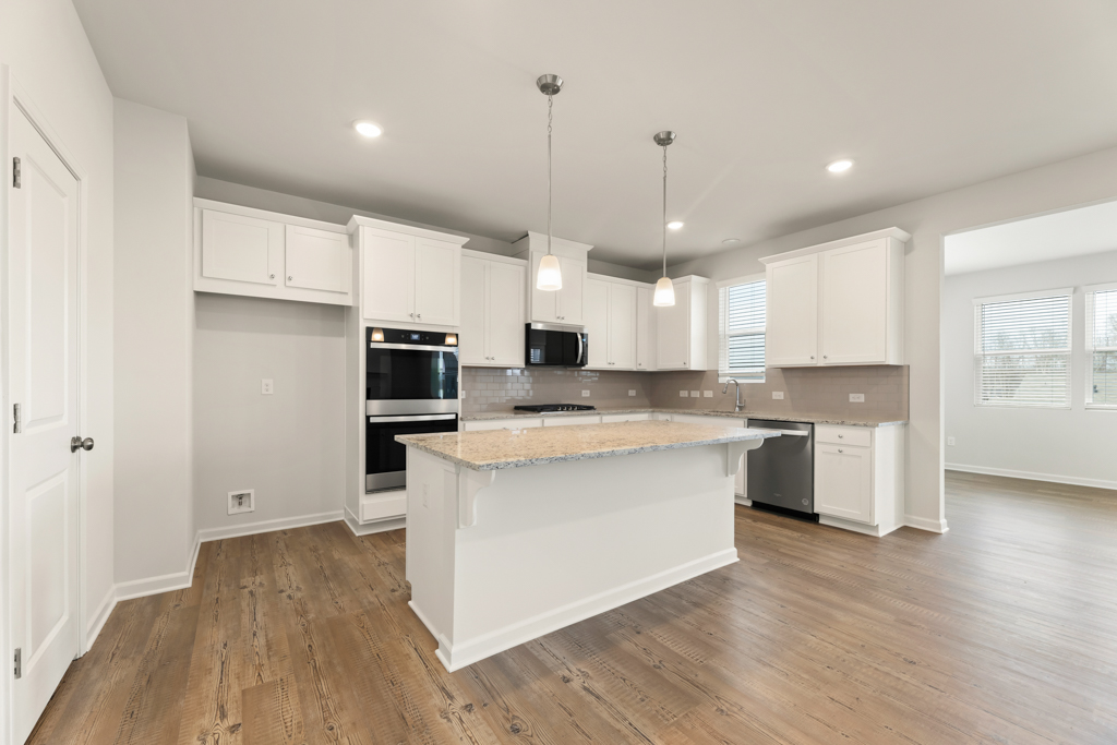 A kitchen with white cabinets.