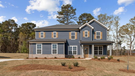 A house with trees in the back.