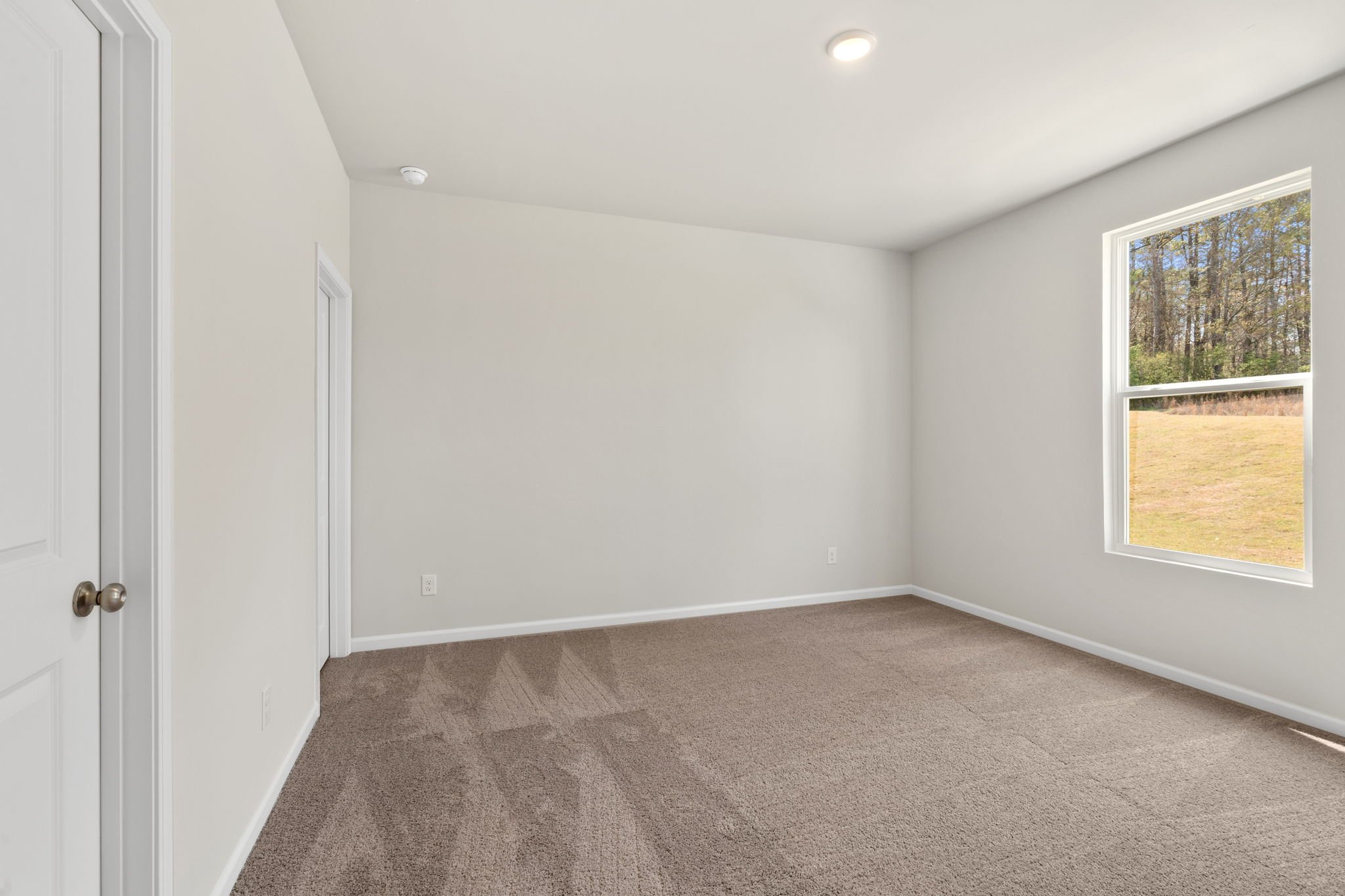 A room with a window and a door.