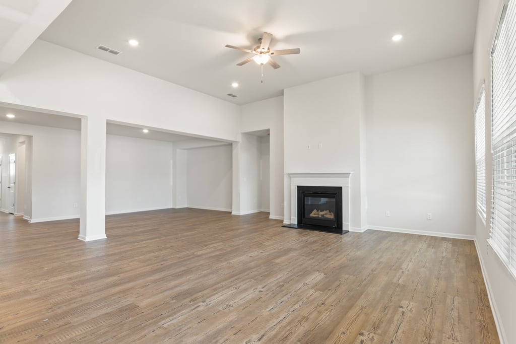 A large empty room with a fireplace.