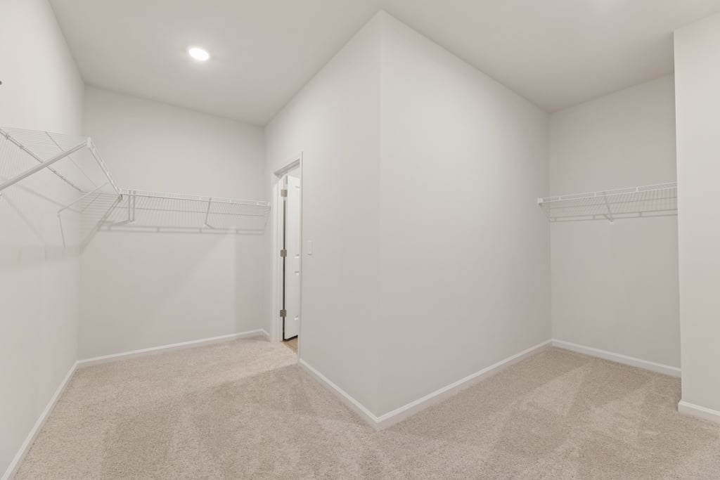 A white hallway with a staircase.