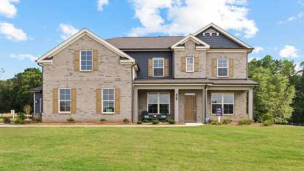 A large house with a lawn in front of it.