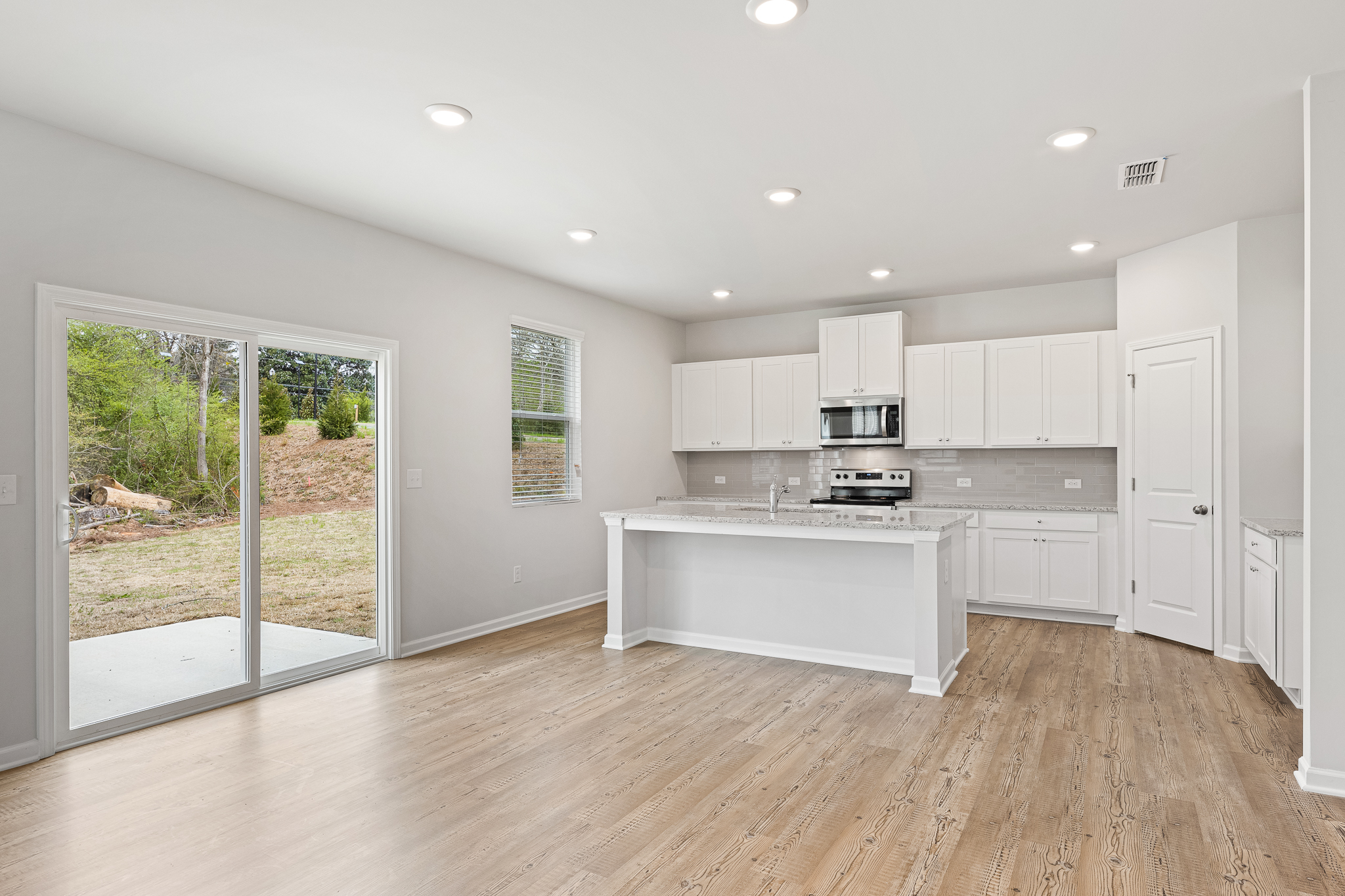A kitchen with white cabinets.