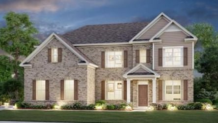 A large house with a lawn in front of it.