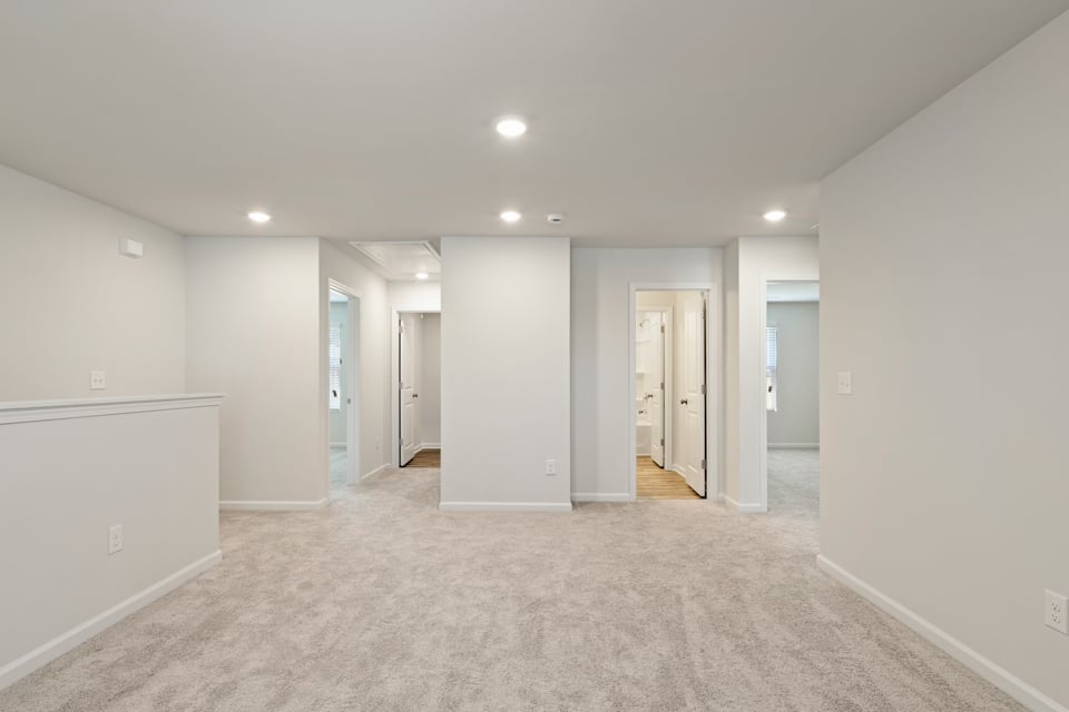 A long hallway with white walls.