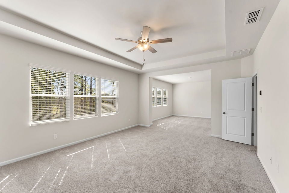A room with a ceiling fan and a window.