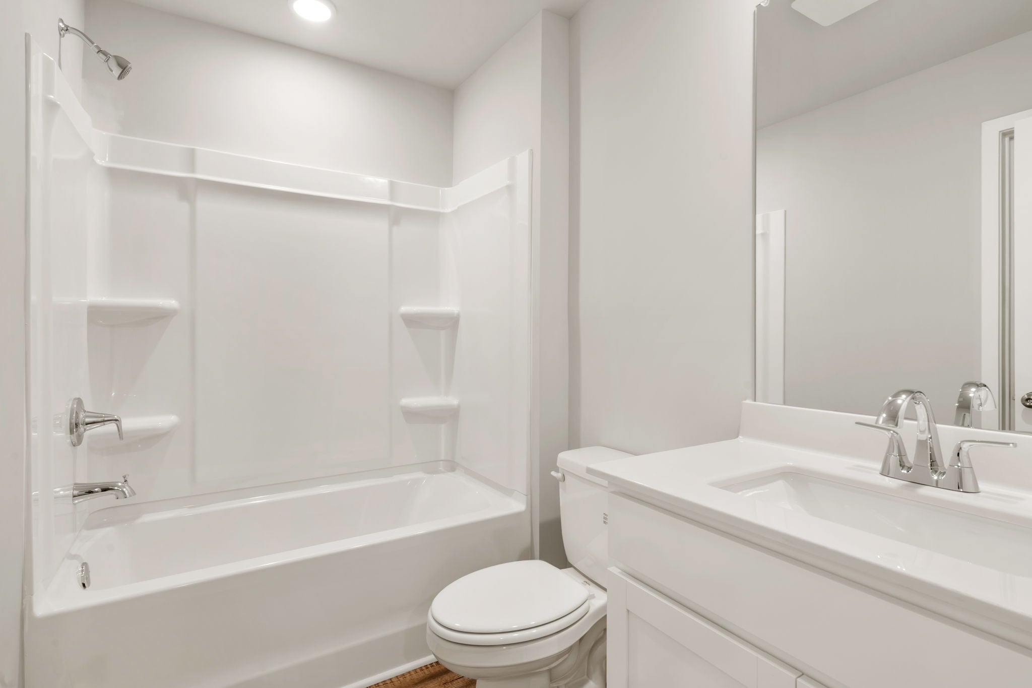 A bathroom with a tub toilet and sink.