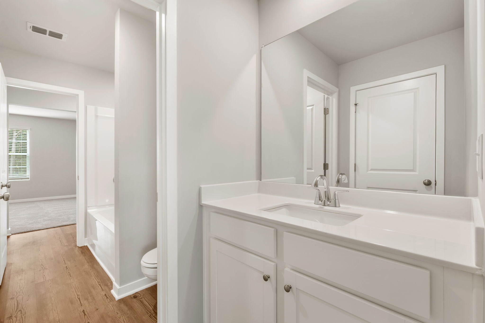 A bathroom with a sink and a toilet.