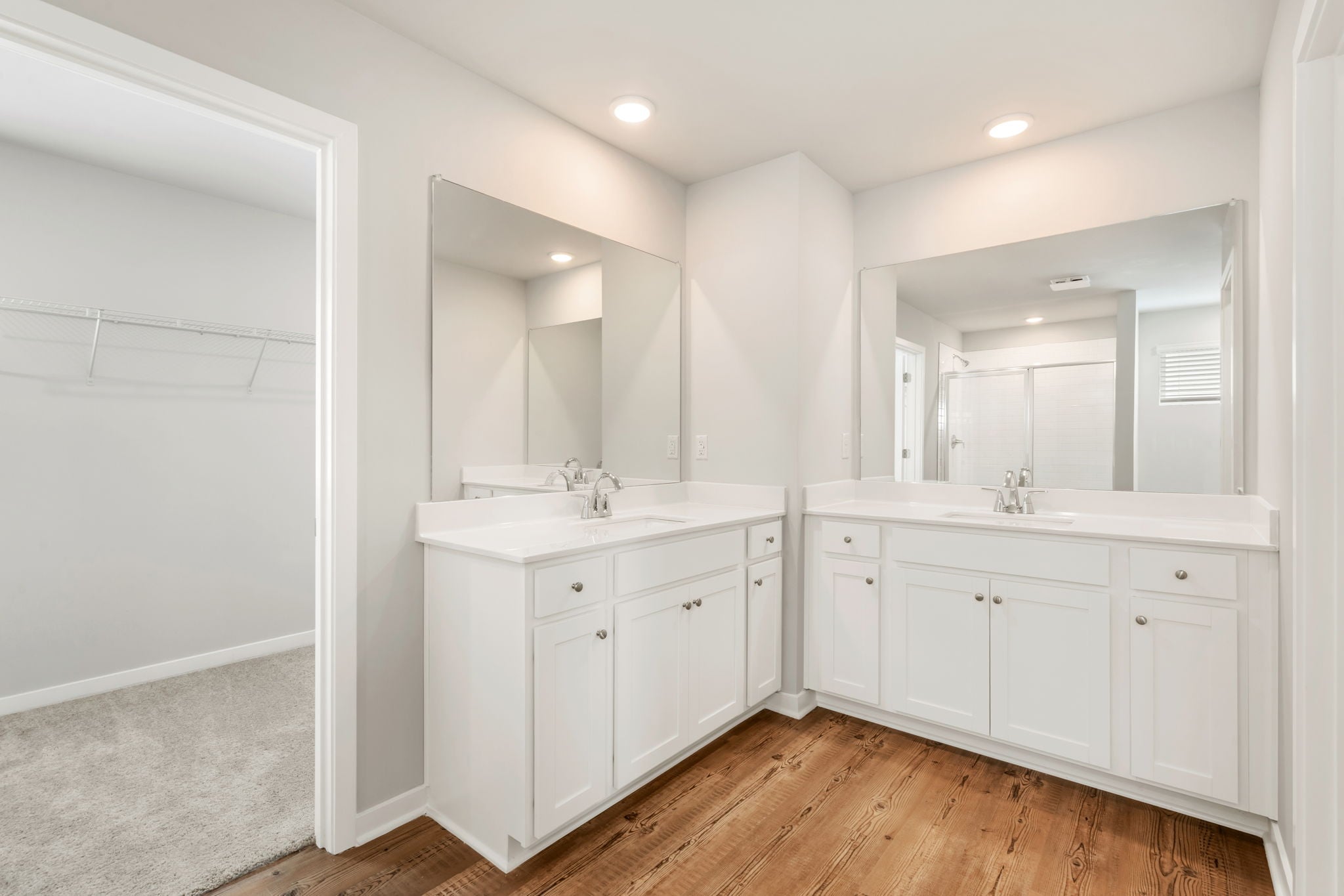 A bathroom with white cabinets.