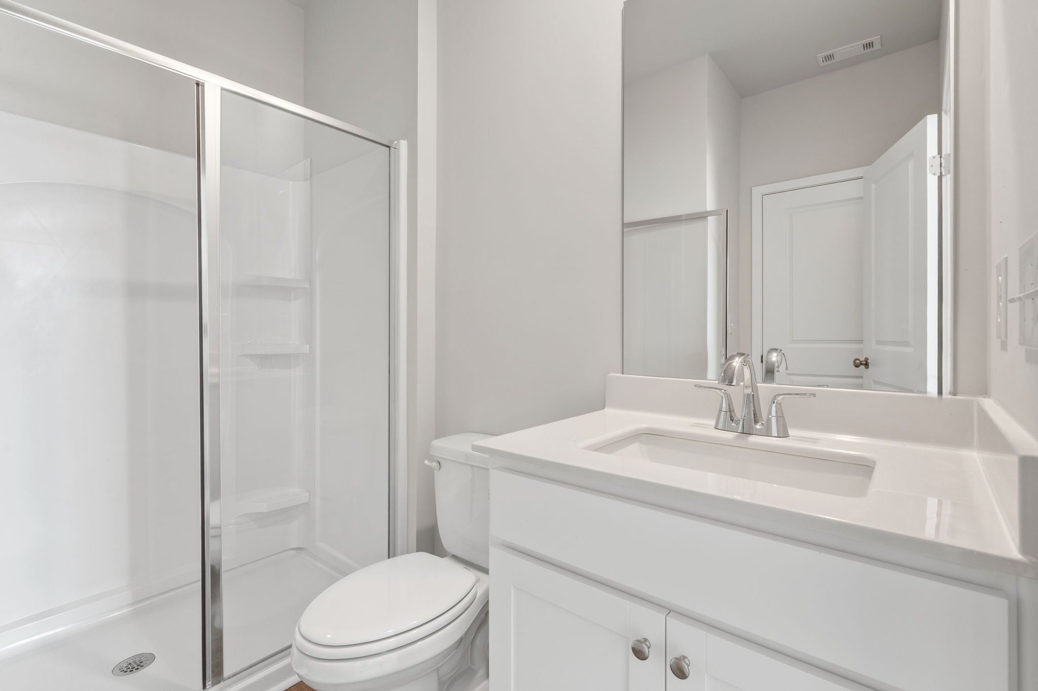 A bathroom with a glass shower.