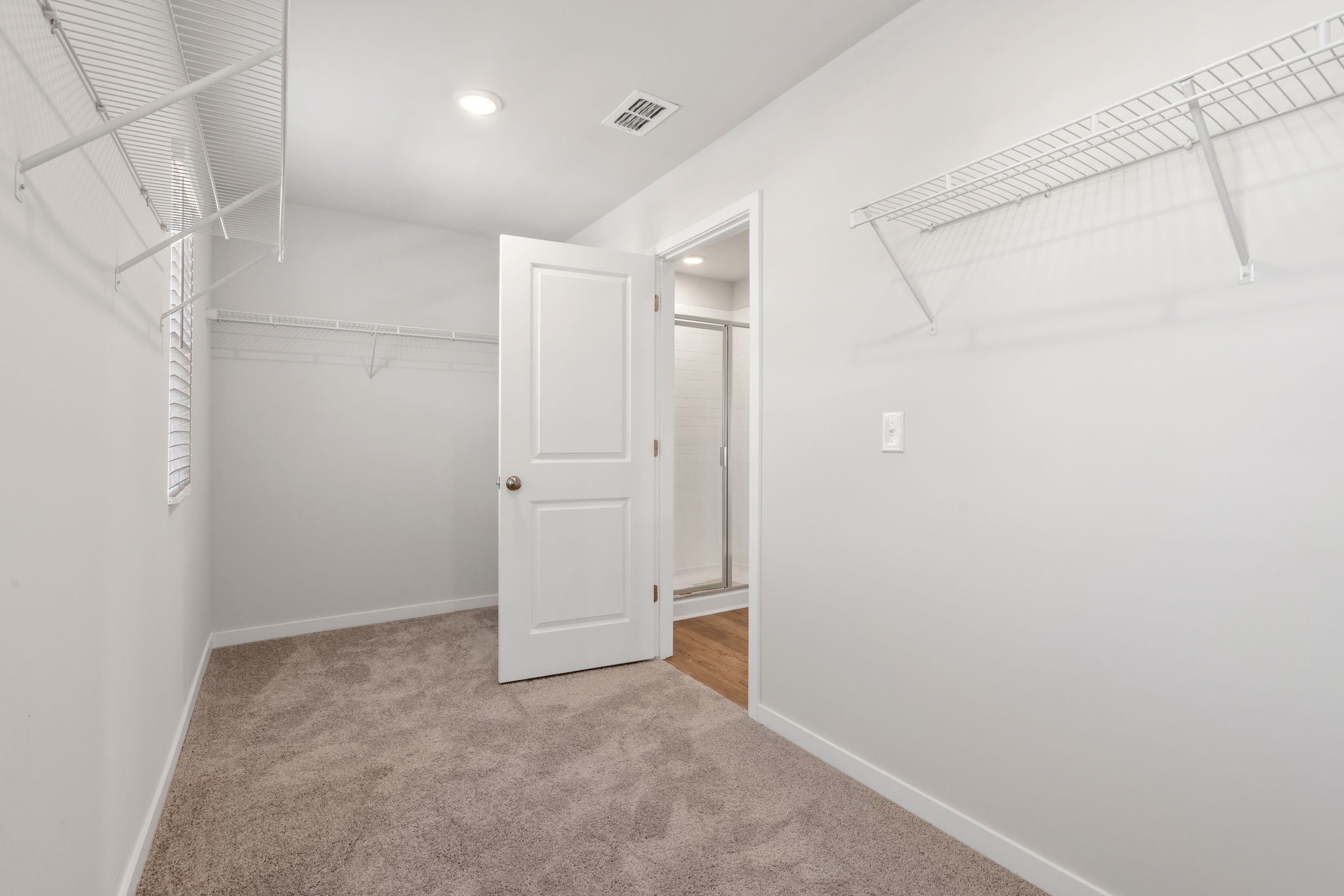 A hallway with white doors.