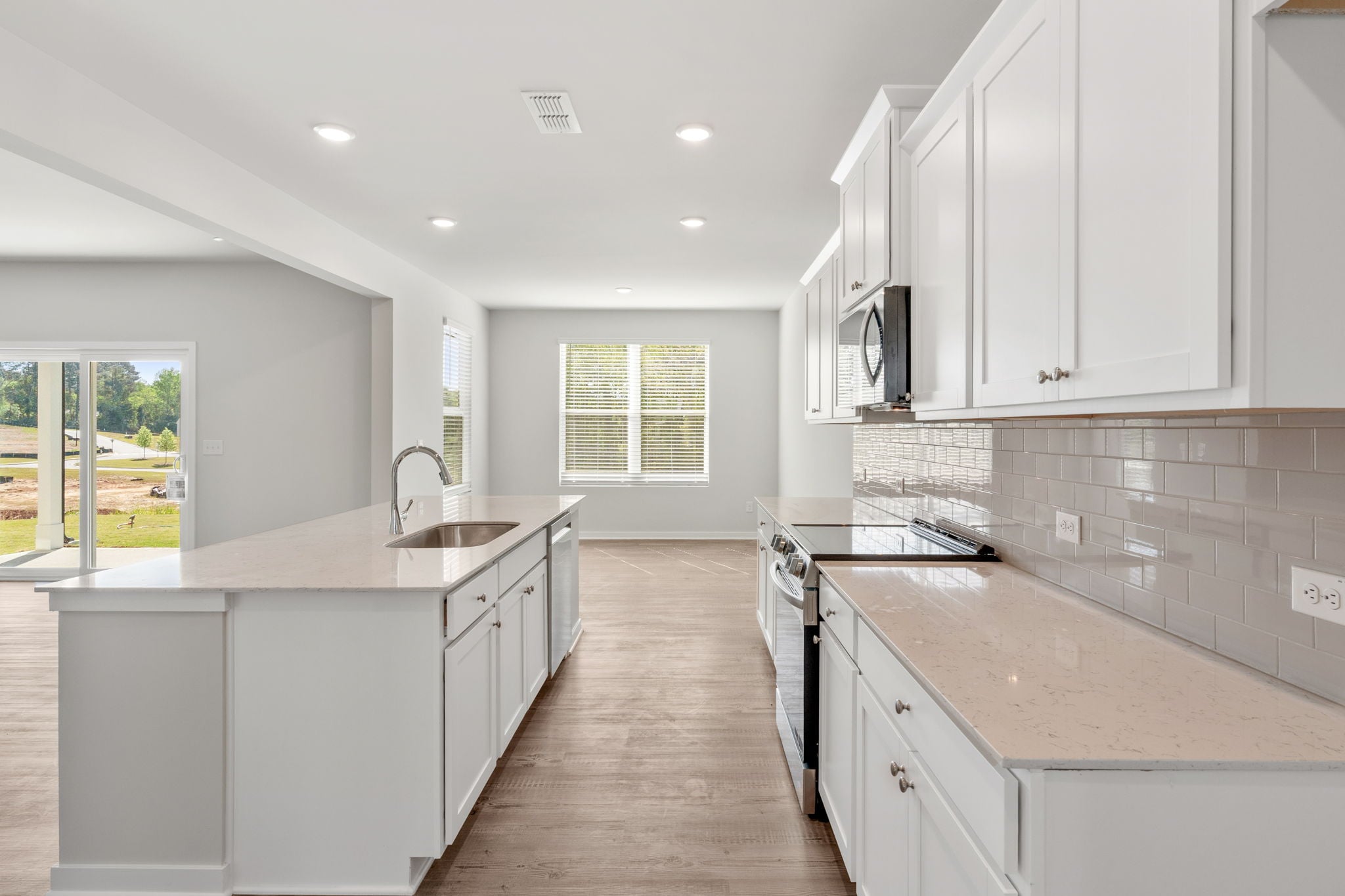 A kitchen with white cabinets.