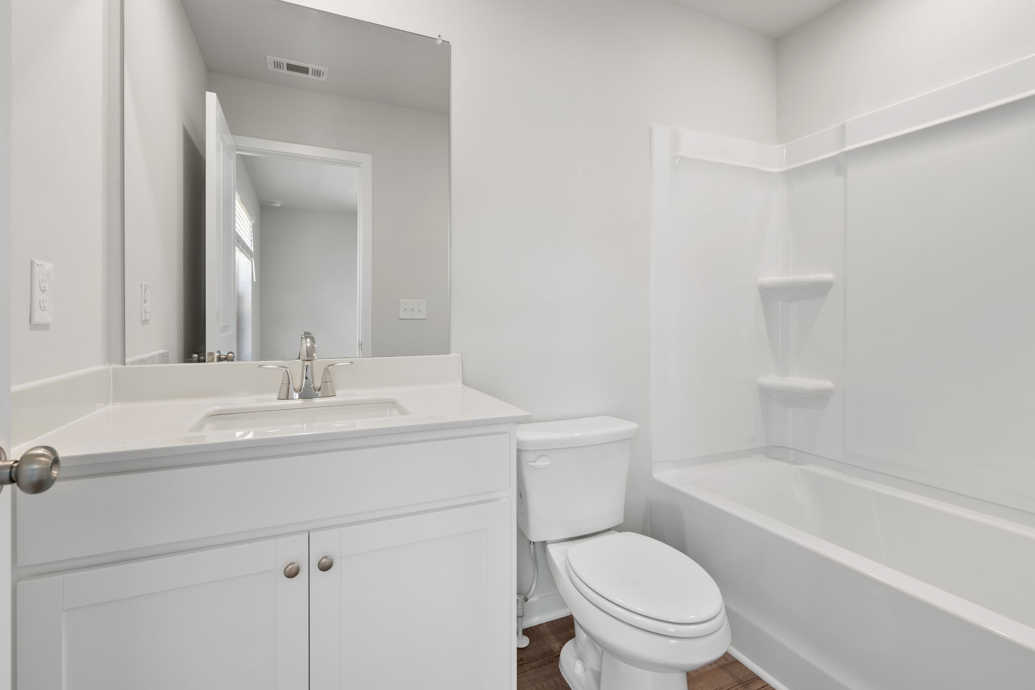A bathroom with a toilet and sink.