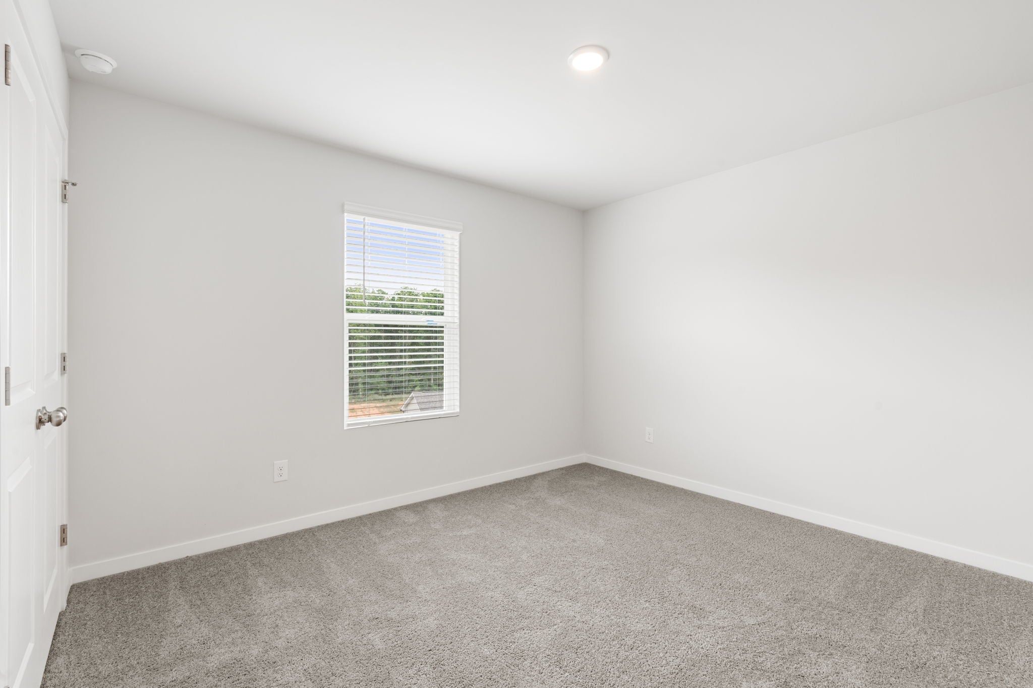 A room with a window and a door.