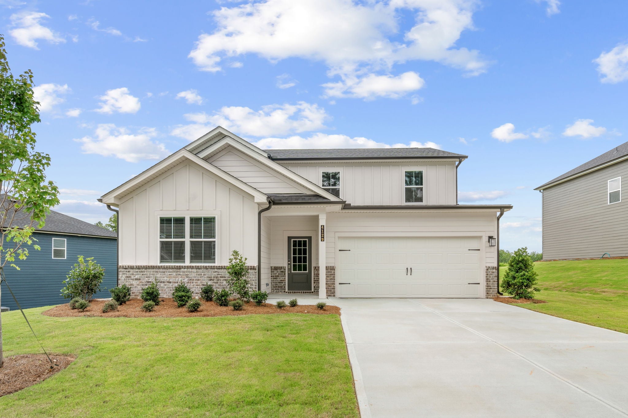 A white house with a garage.