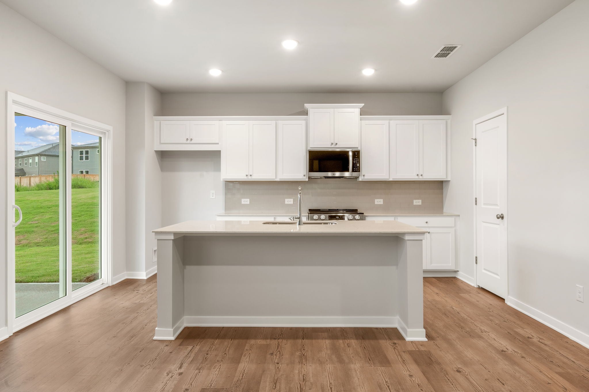 A kitchen with white cabinets.