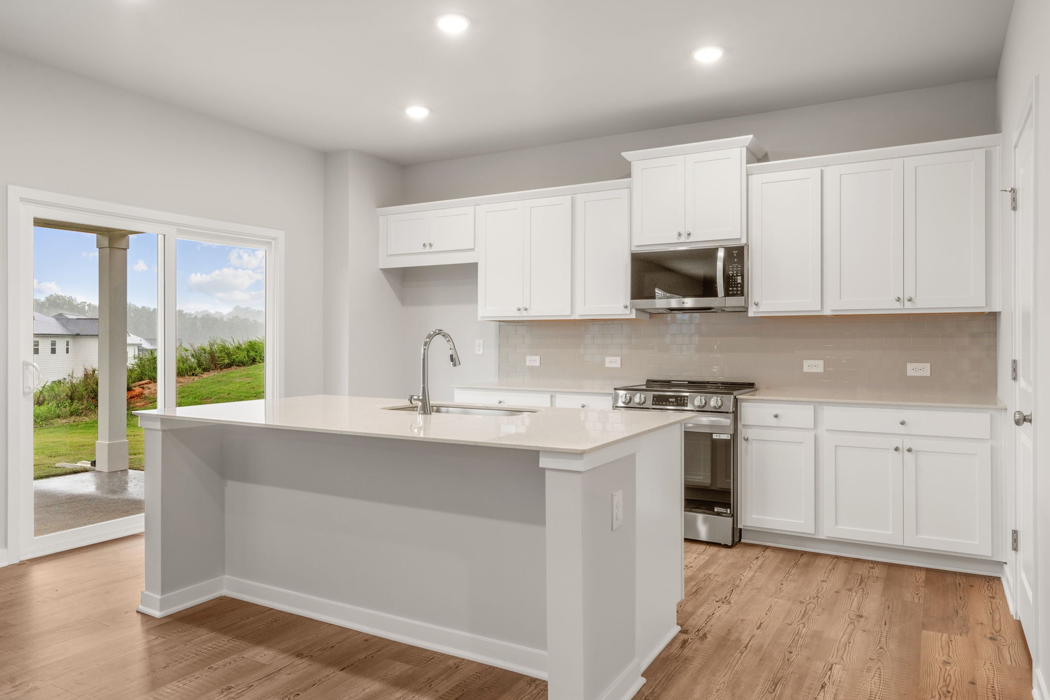 A kitchen with white cabinets.