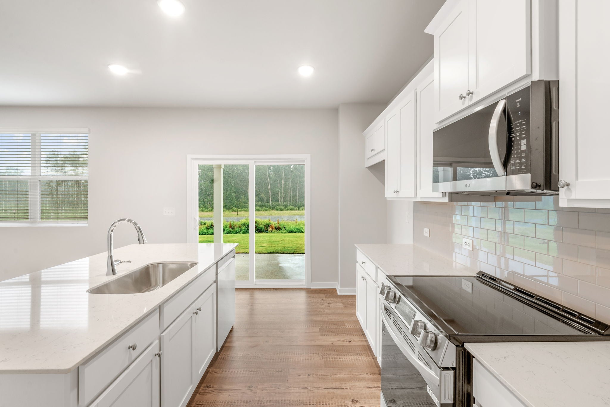 A kitchen with white cabinets.