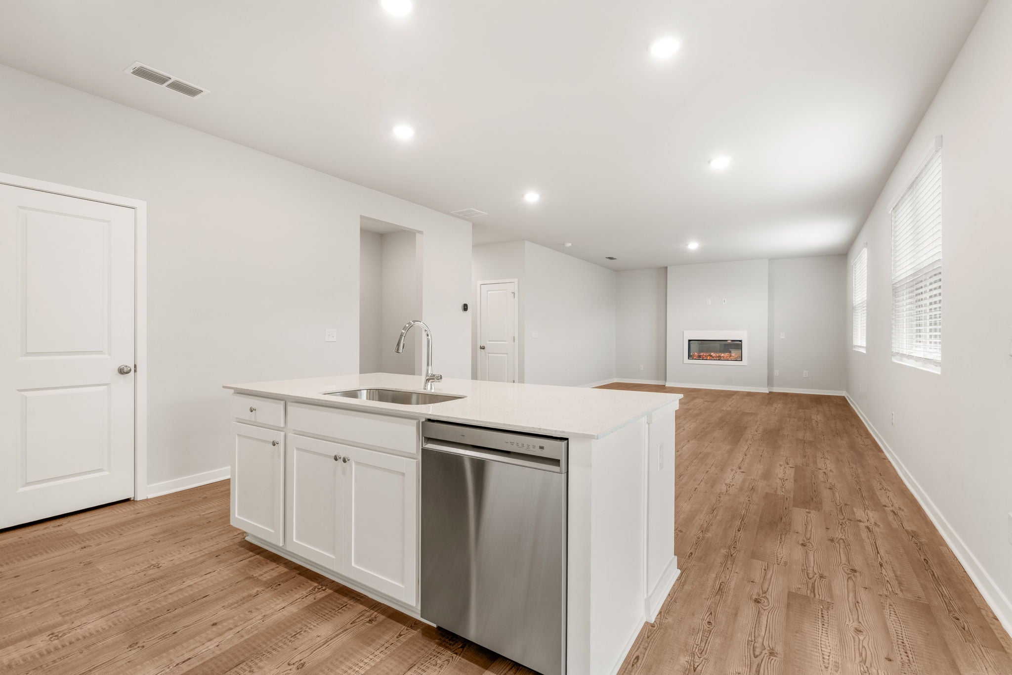 A kitchen with white cabinets.