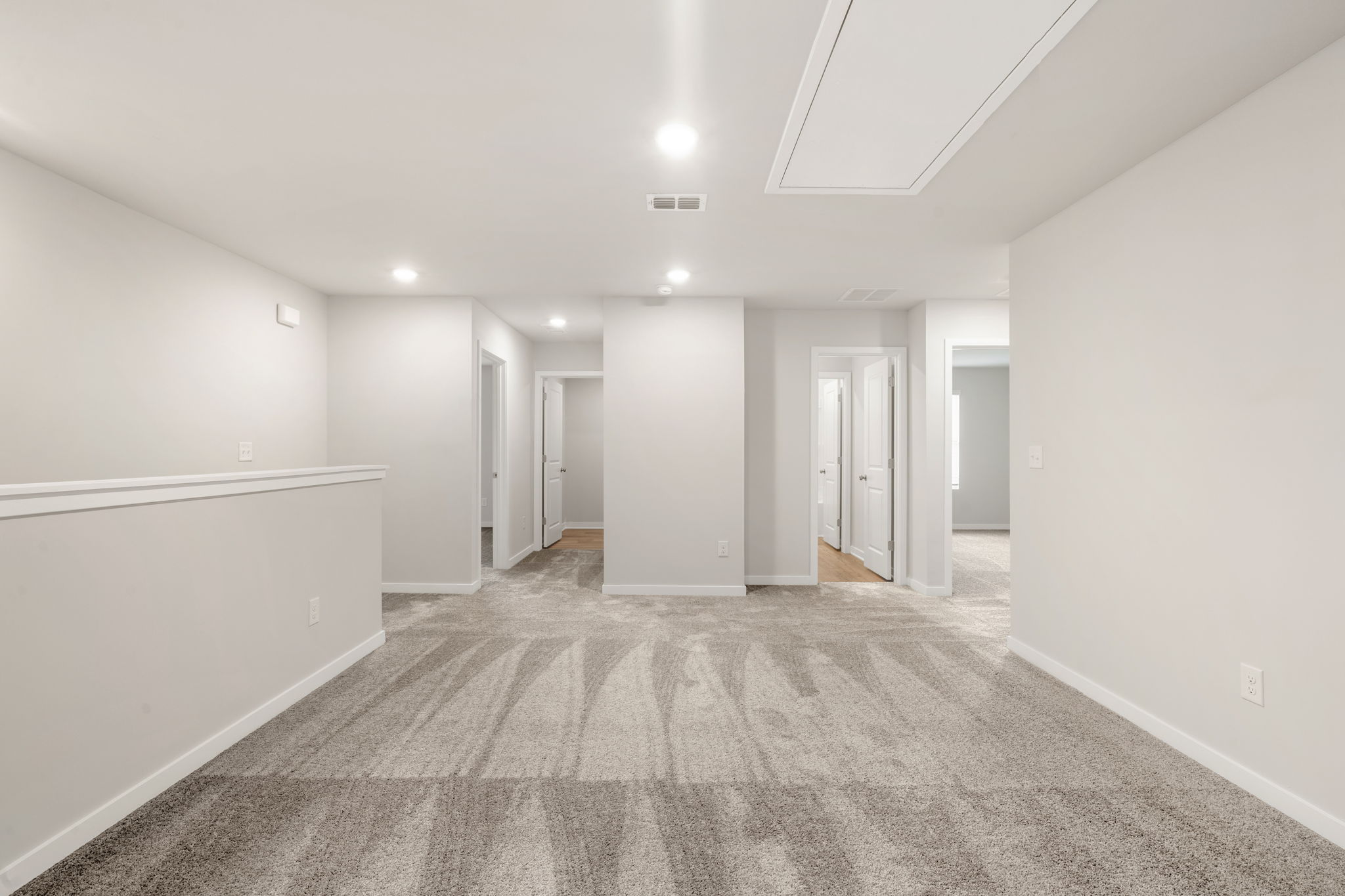 A long hallway with white walls.