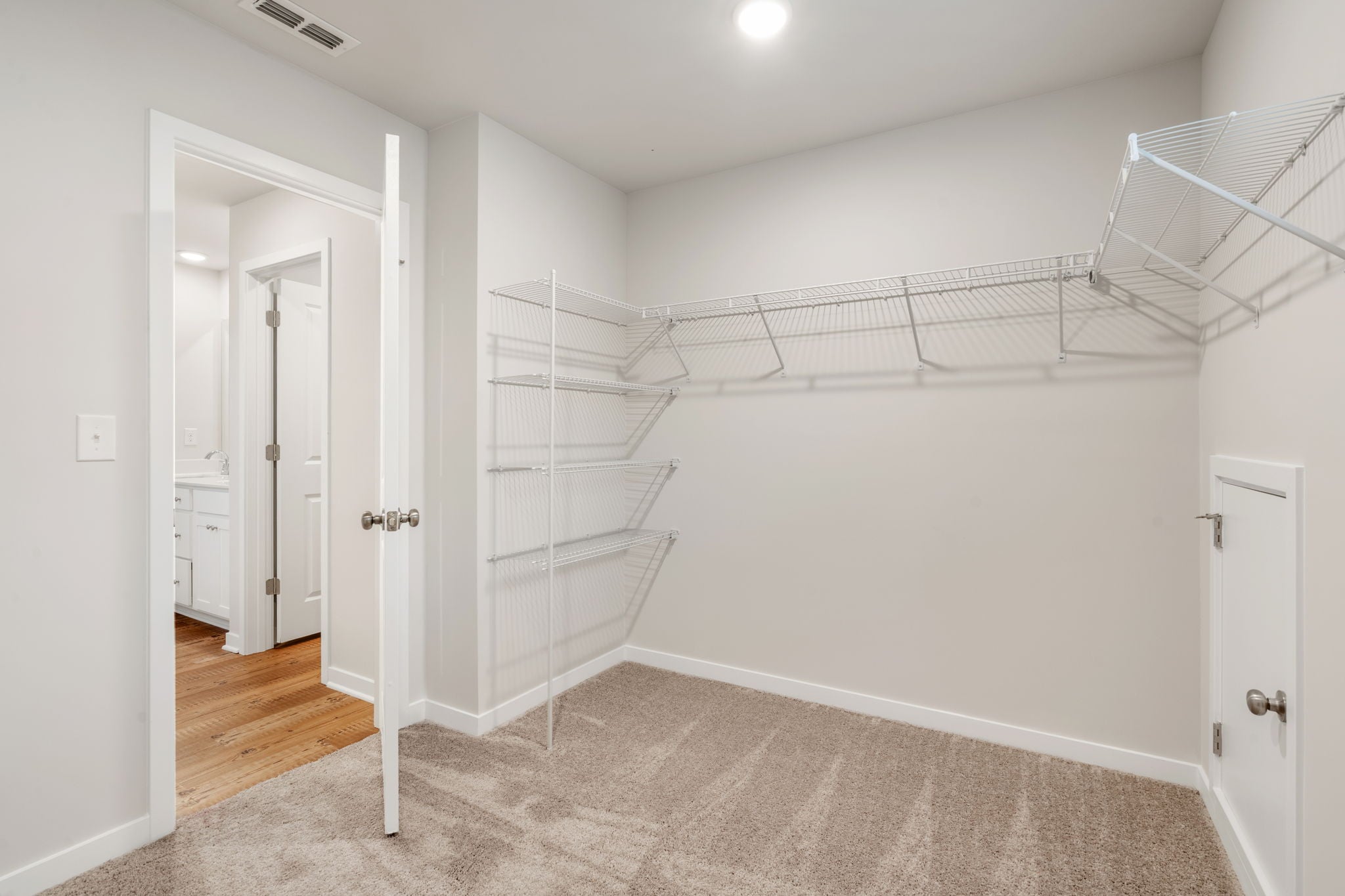 A room with white walls and a staircase.