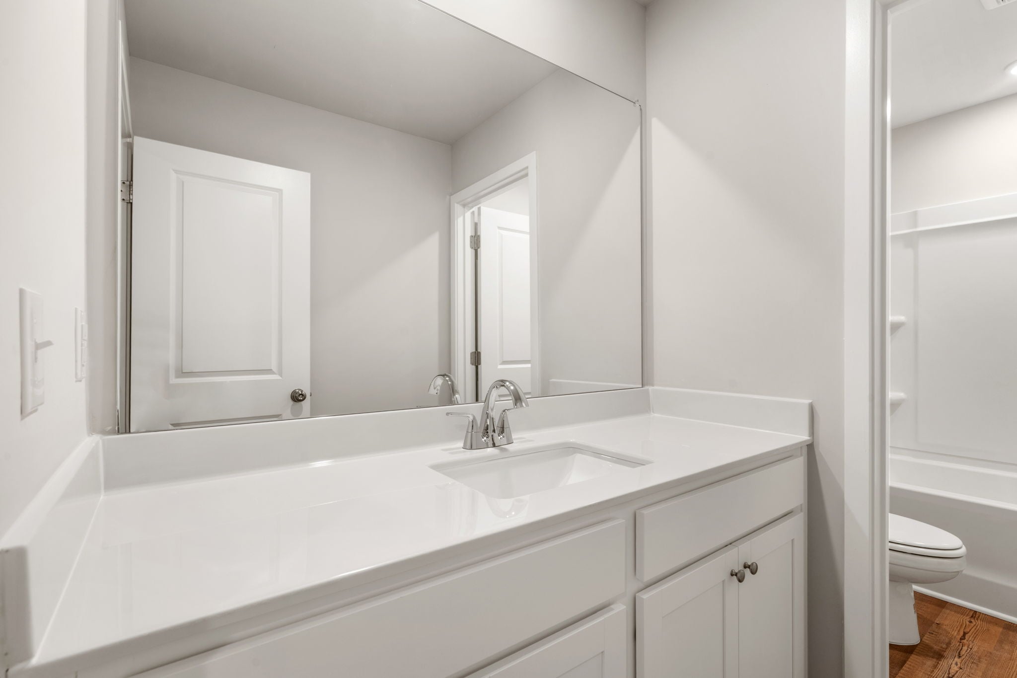 A bathroom with a sink and a toilet.
