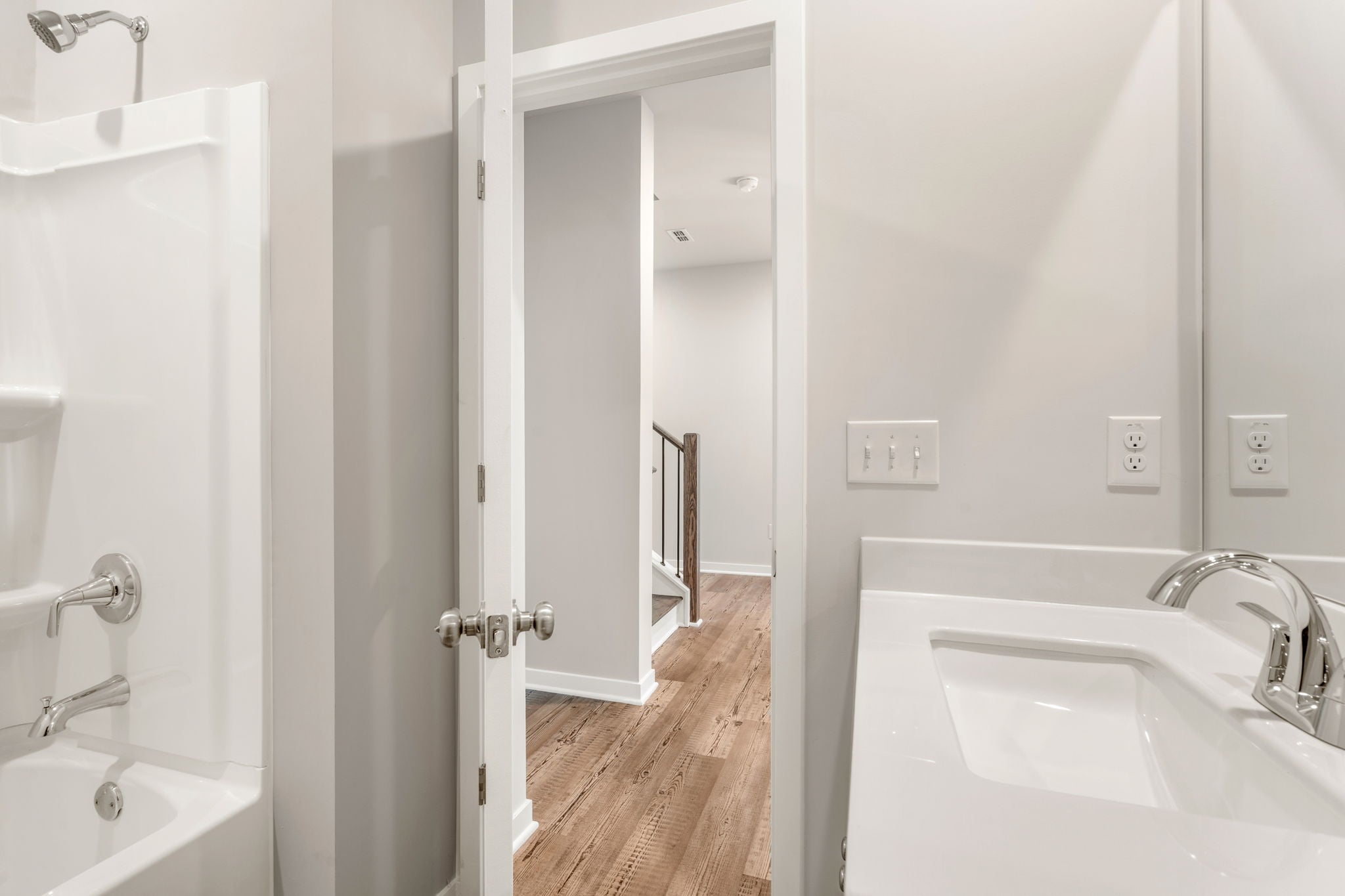 A bathroom with a sink and a shower.