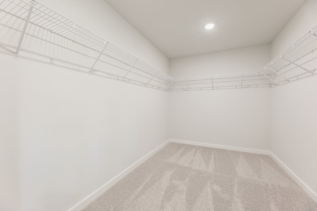 A white hallway with a white wall.