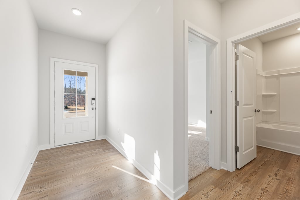 A room with white walls and a wood floor.