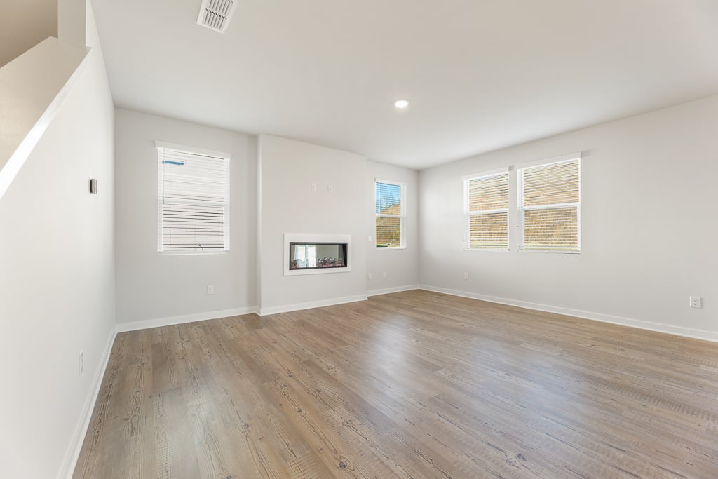 A room with a wood floor and white walls.