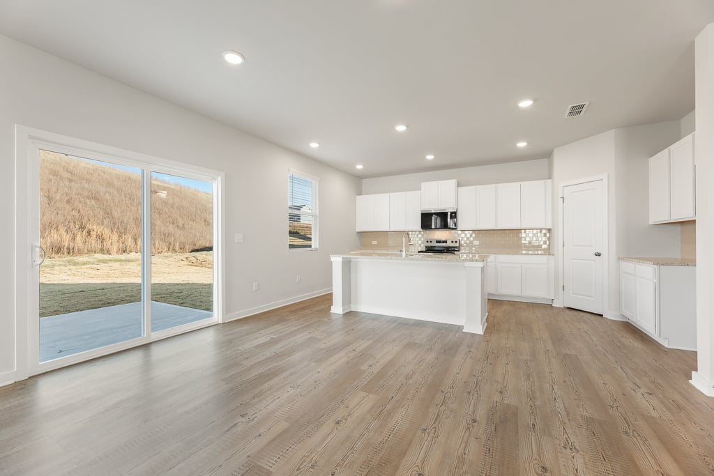 A kitchen with a wood floor.