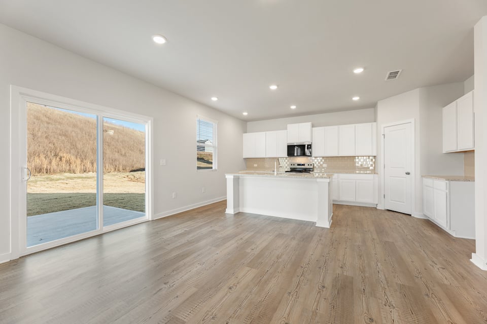A kitchen with a wood floor.