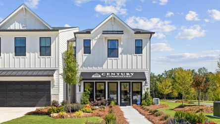 A white building with a sign on it.