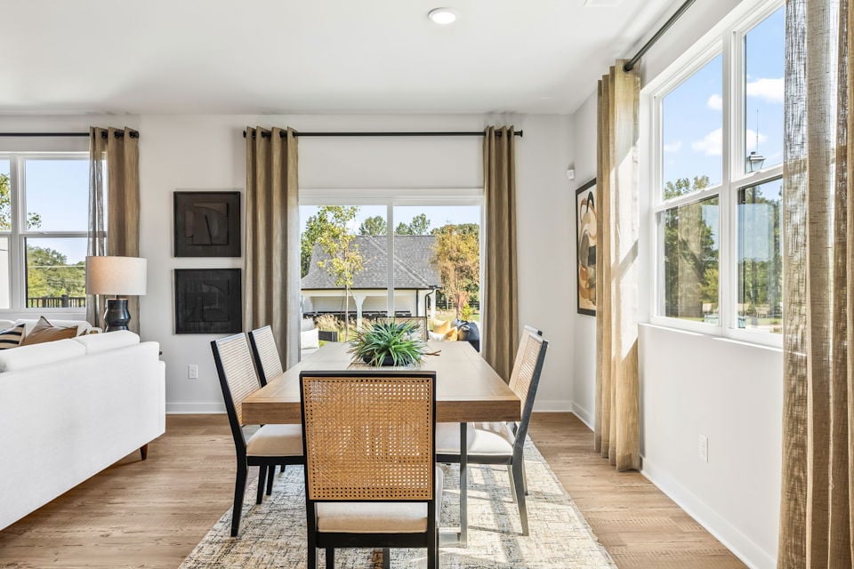 A dining room with a large window.