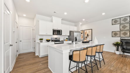 A kitchen with white cabinets.