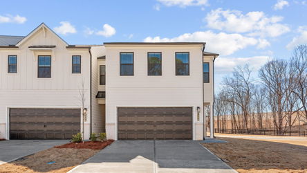 A white house with a garage.