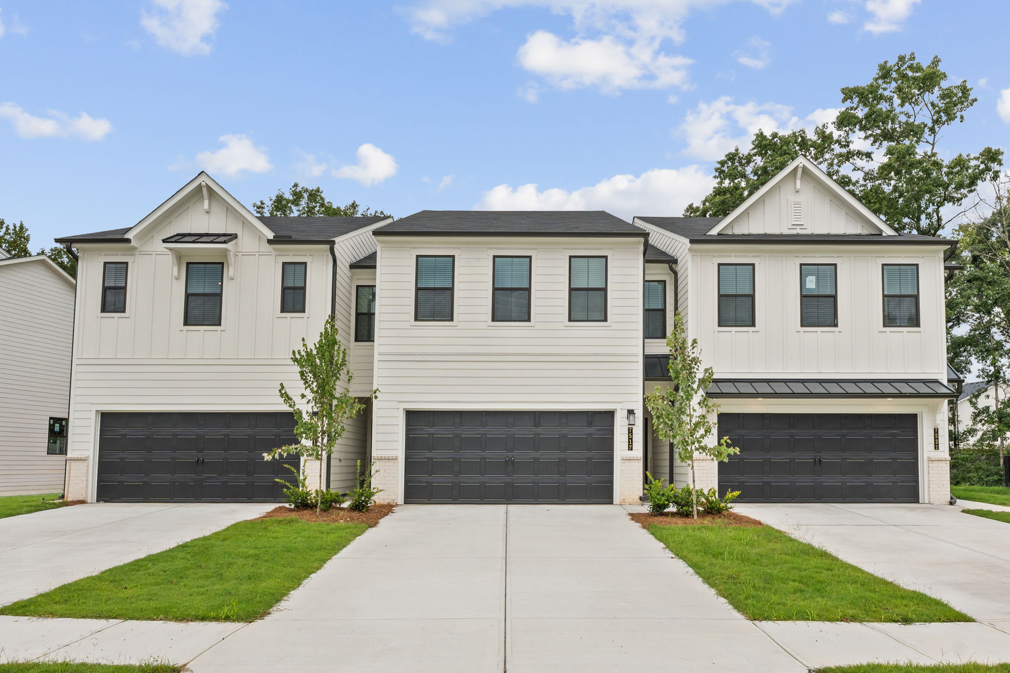 A white building with a driveway.