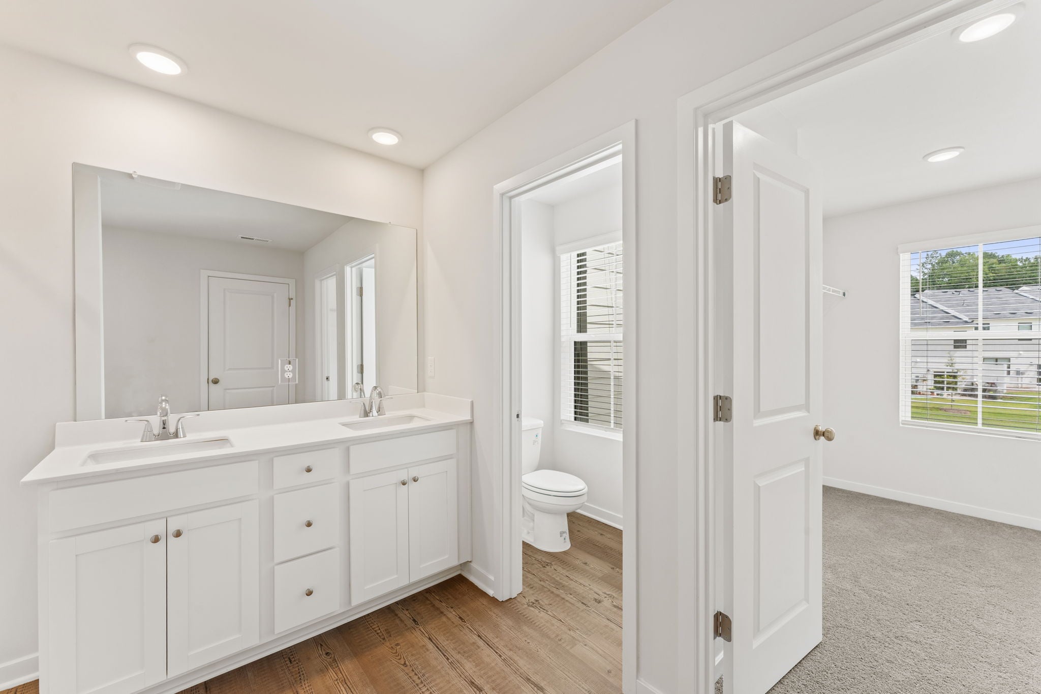 A bathroom with white cabinets.