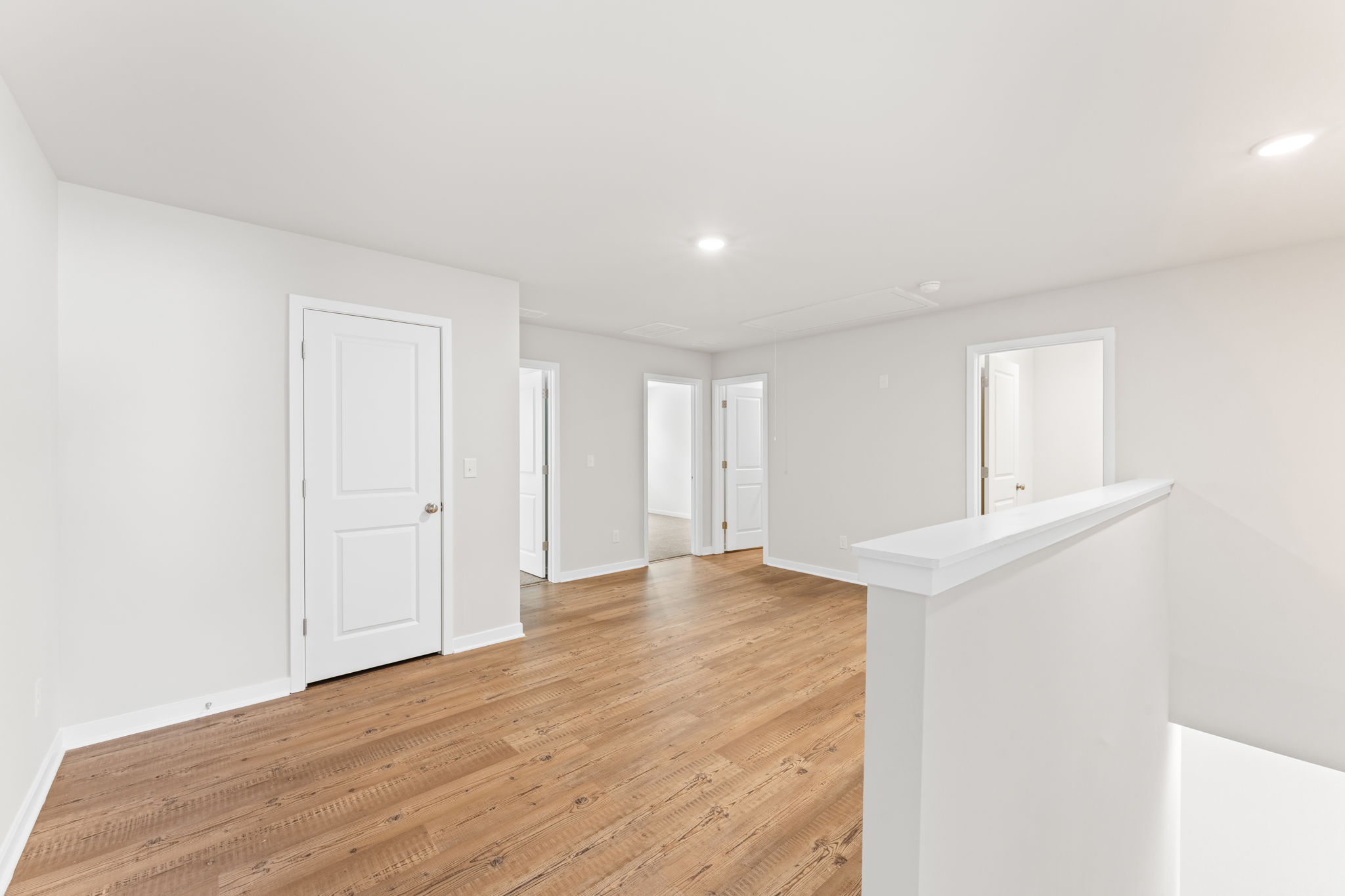A room with white walls and a wood floor.