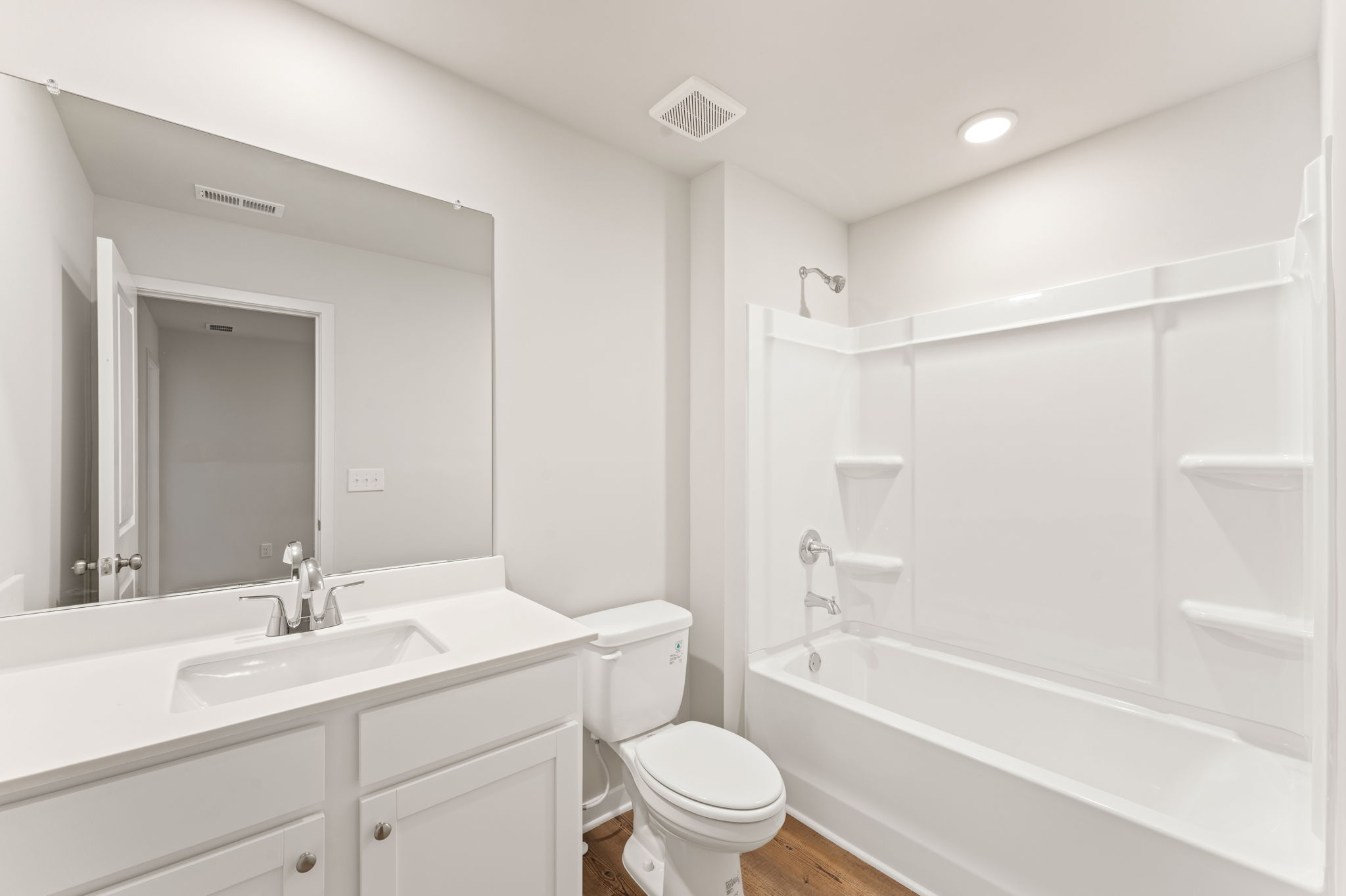 A bathroom with a tub sink and toilet.