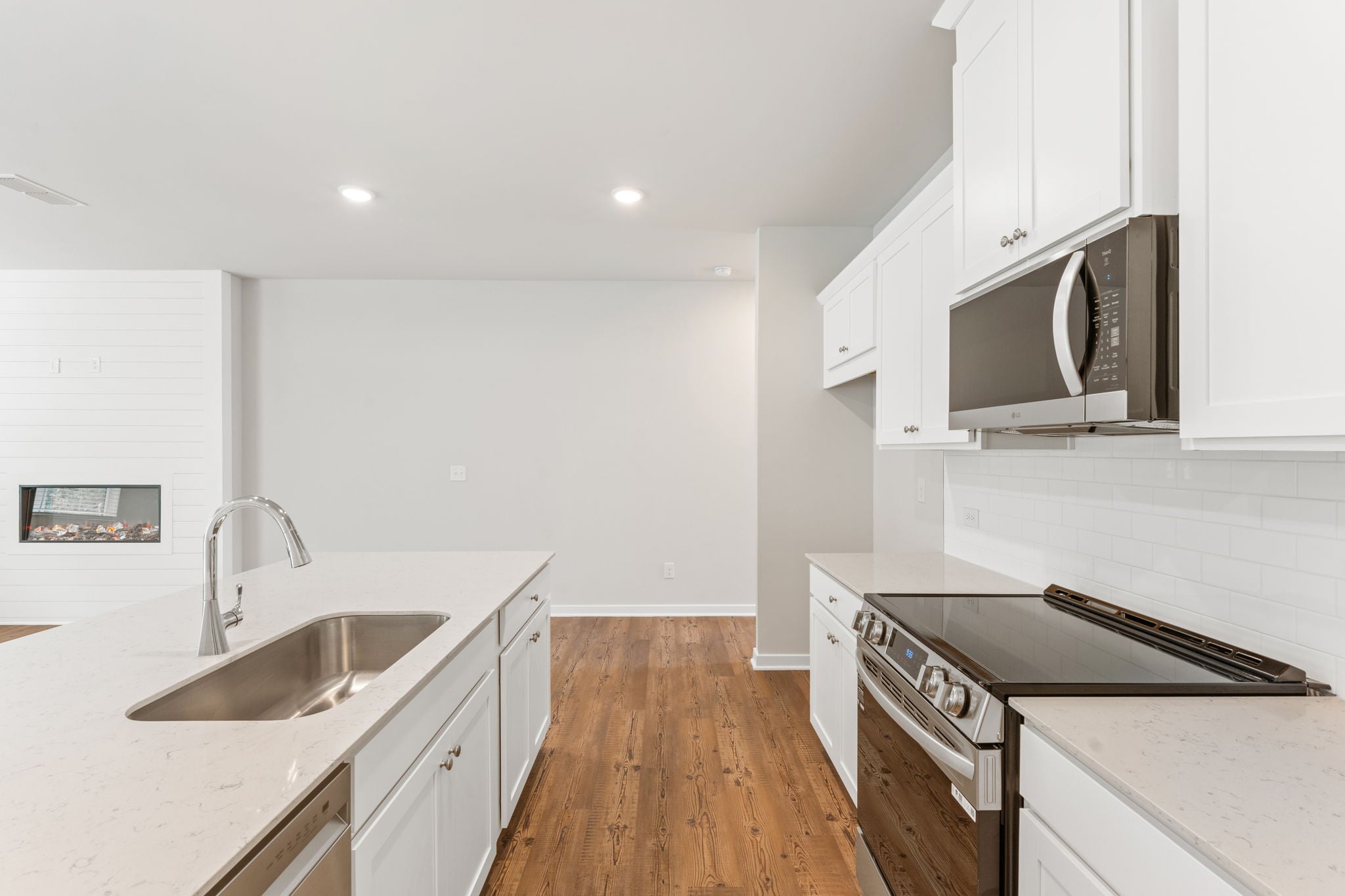 A kitchen with white cabinets.