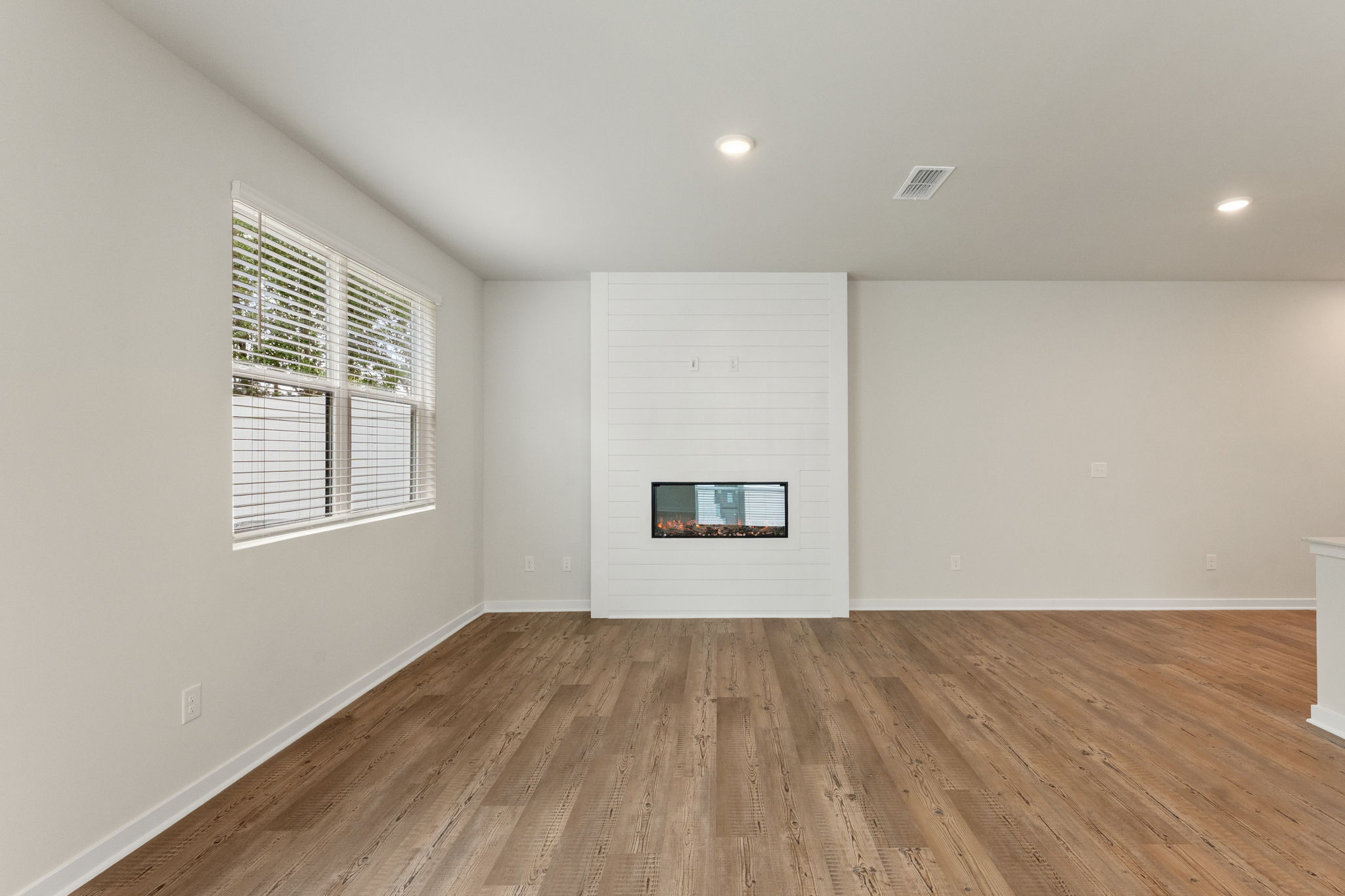 A room with a wood floor and a wood floor.