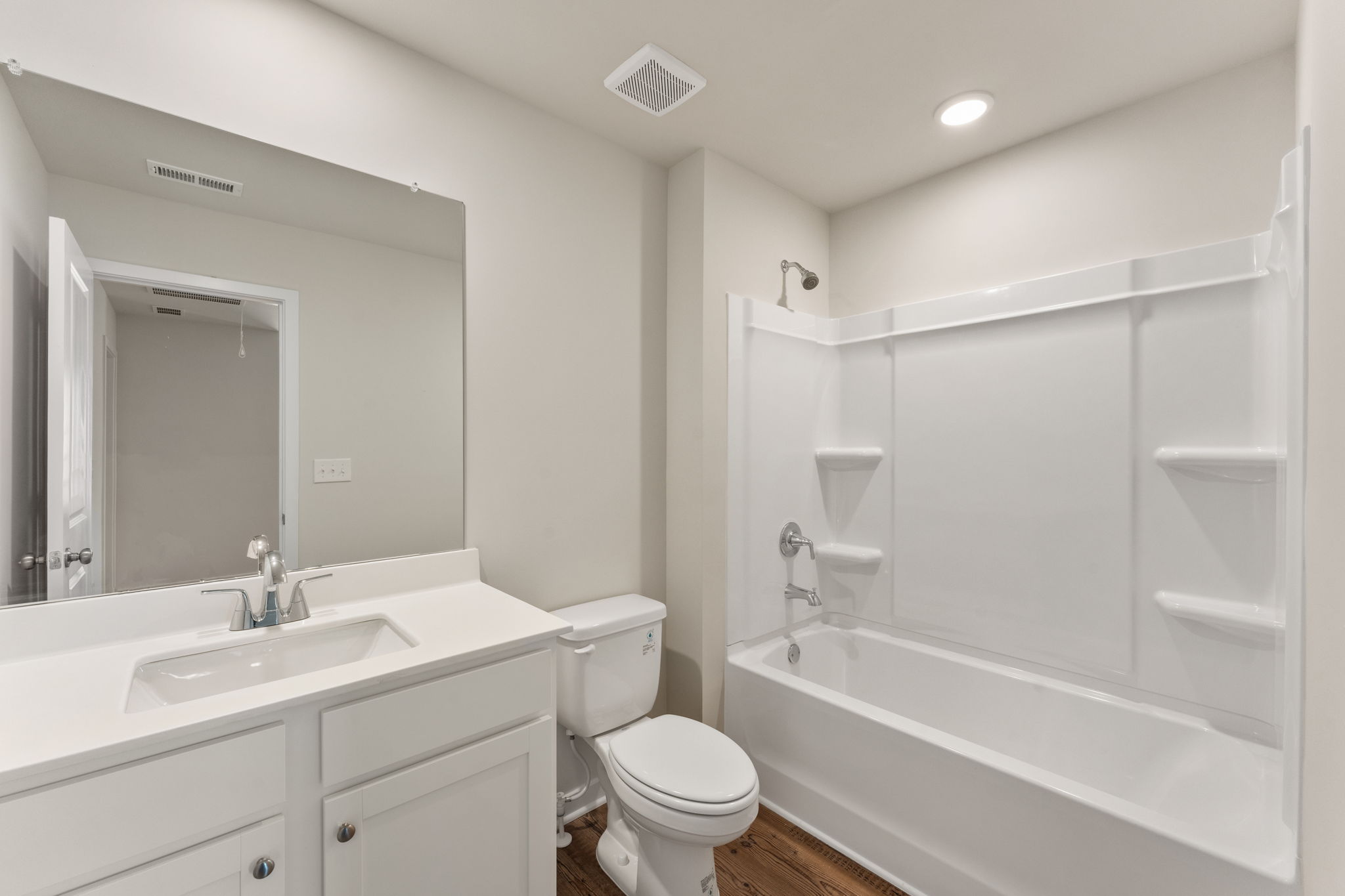 A bathroom with a tub sink and toilet.