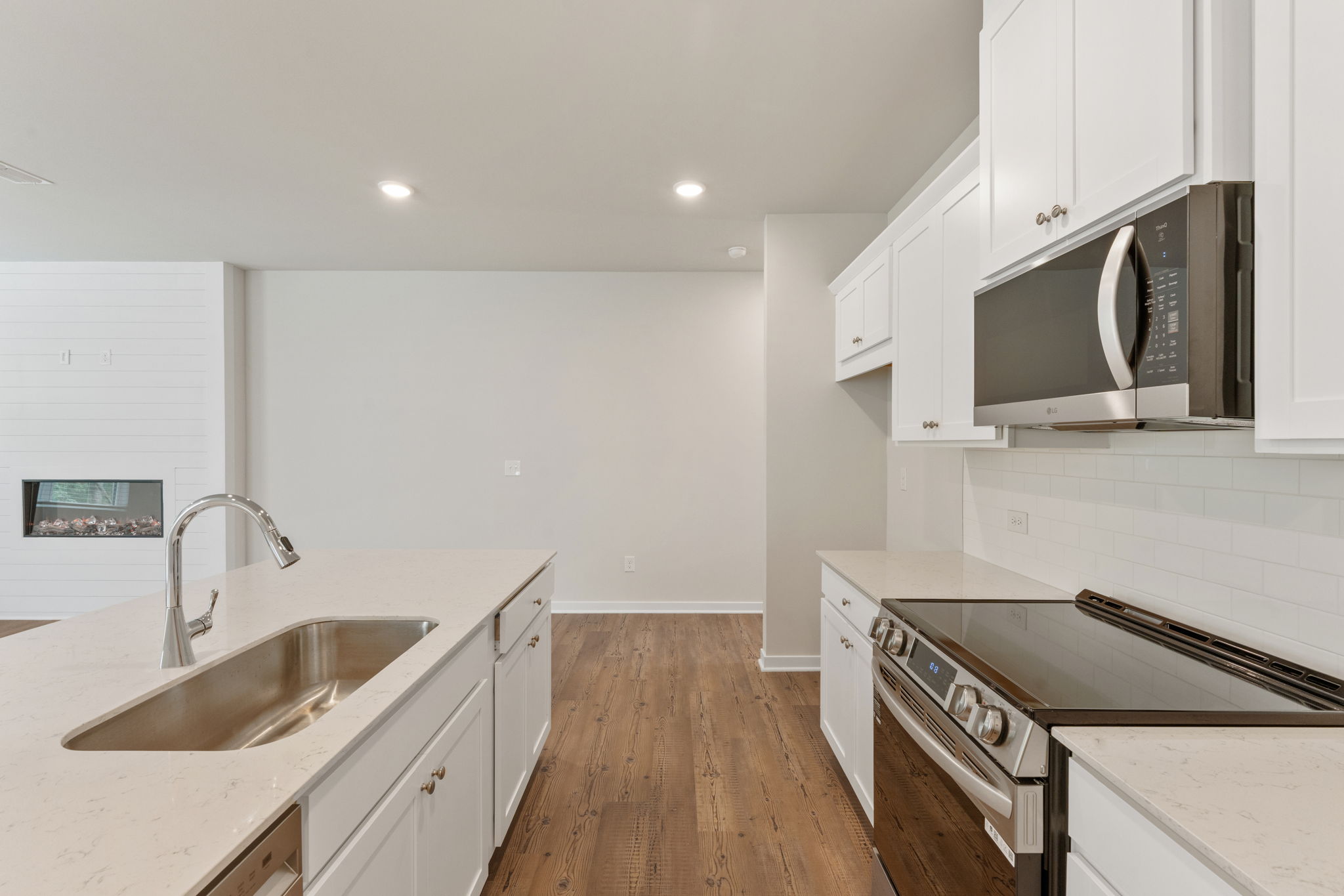 A kitchen with white cabinets.