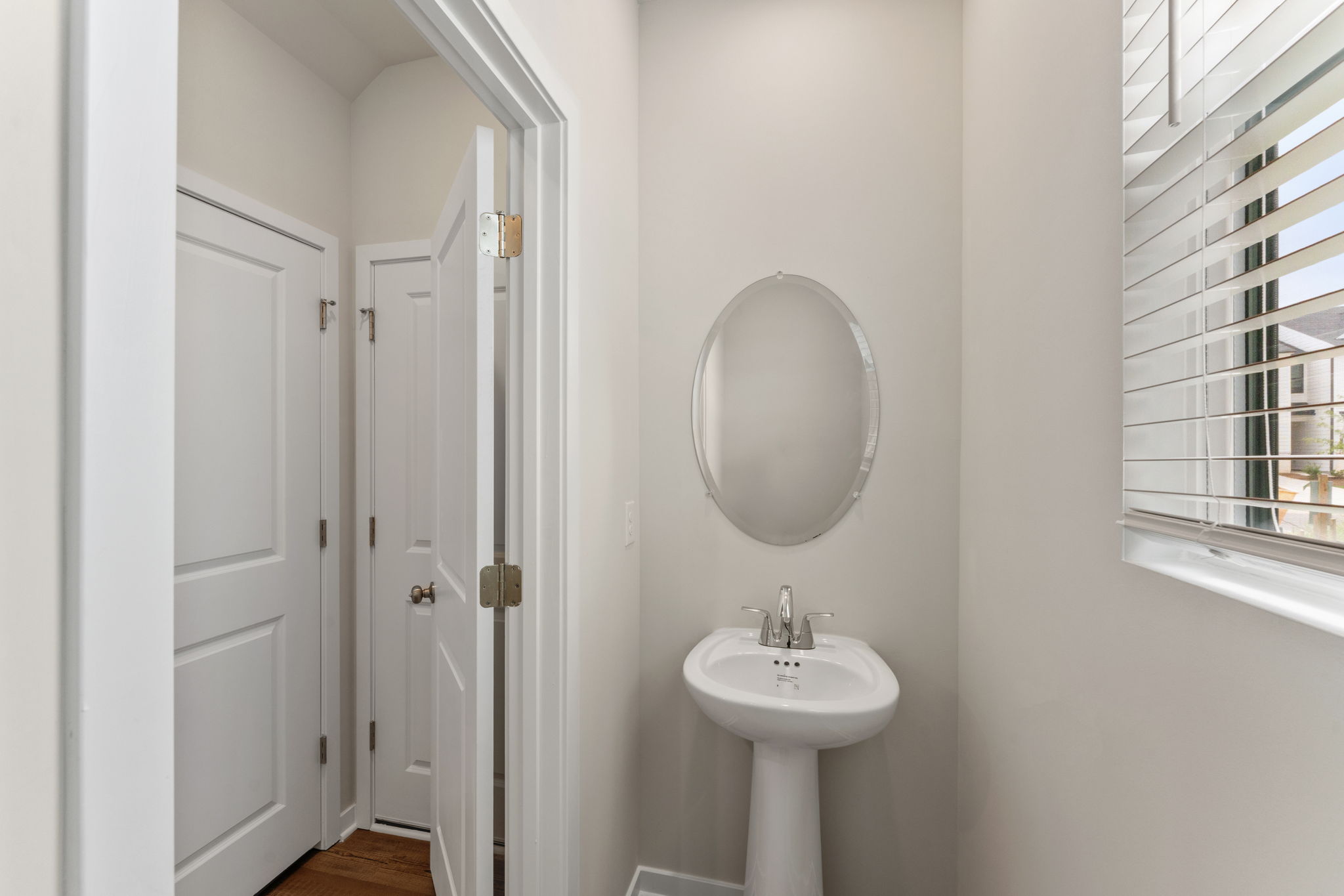 A bathroom with a mirror and sink.
